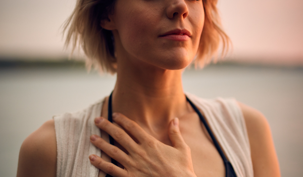 a woman with her hand on her chest